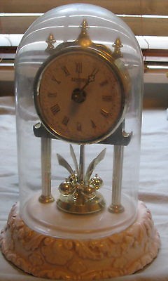   ceramic base Anniversary Clock w/glass dome 4 ball pendulum 8 inc